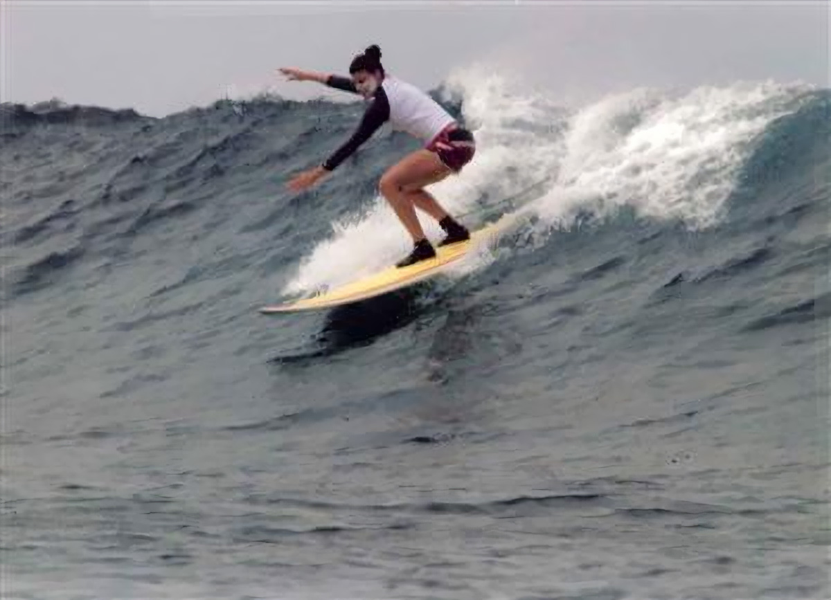 Gabriela Yariv surfing riding a wave